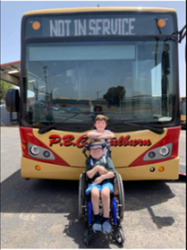 Beau in front of school bus
