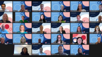 Photo of large group smiling on a virtual meeting