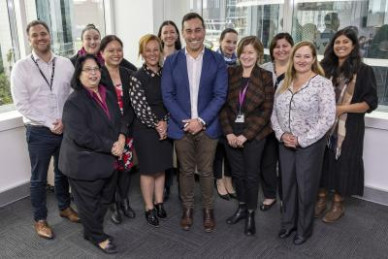 Group of people in office smiling to camera