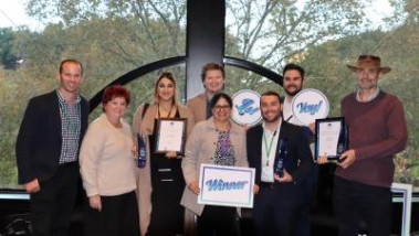 8 NSW HealthShare employees smiling holding trophies and certificates that say Chief Executive Award for Citizenship